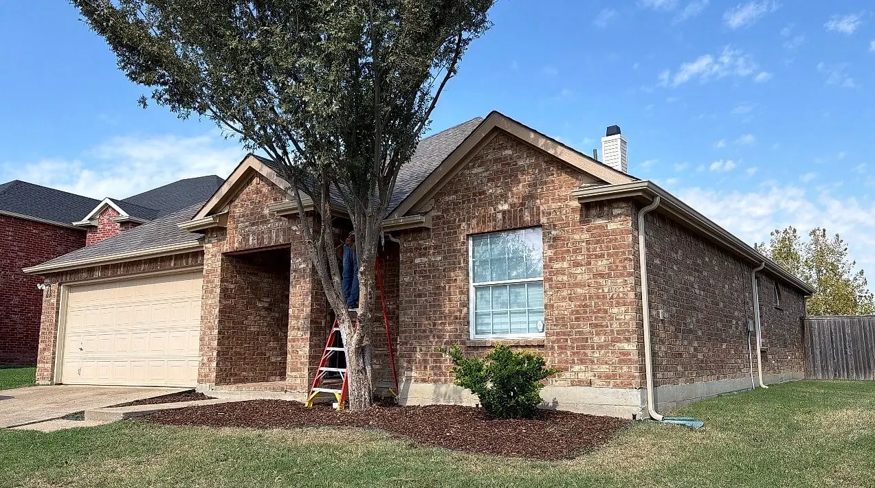 The same home with new seamless gutters and a downspout at the corner