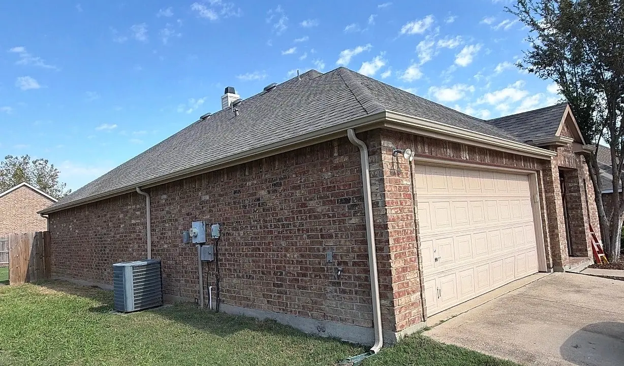 The same side with a new seamless gutter run and downspout